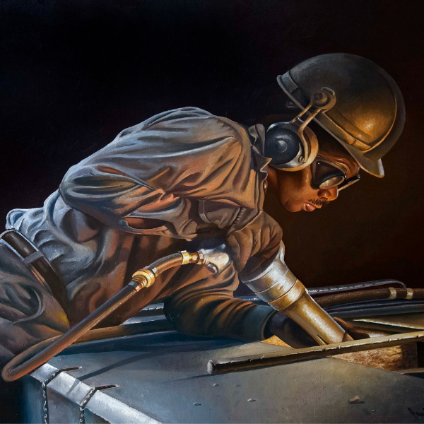 a man wearing a helmet and goggles working on a metal structure