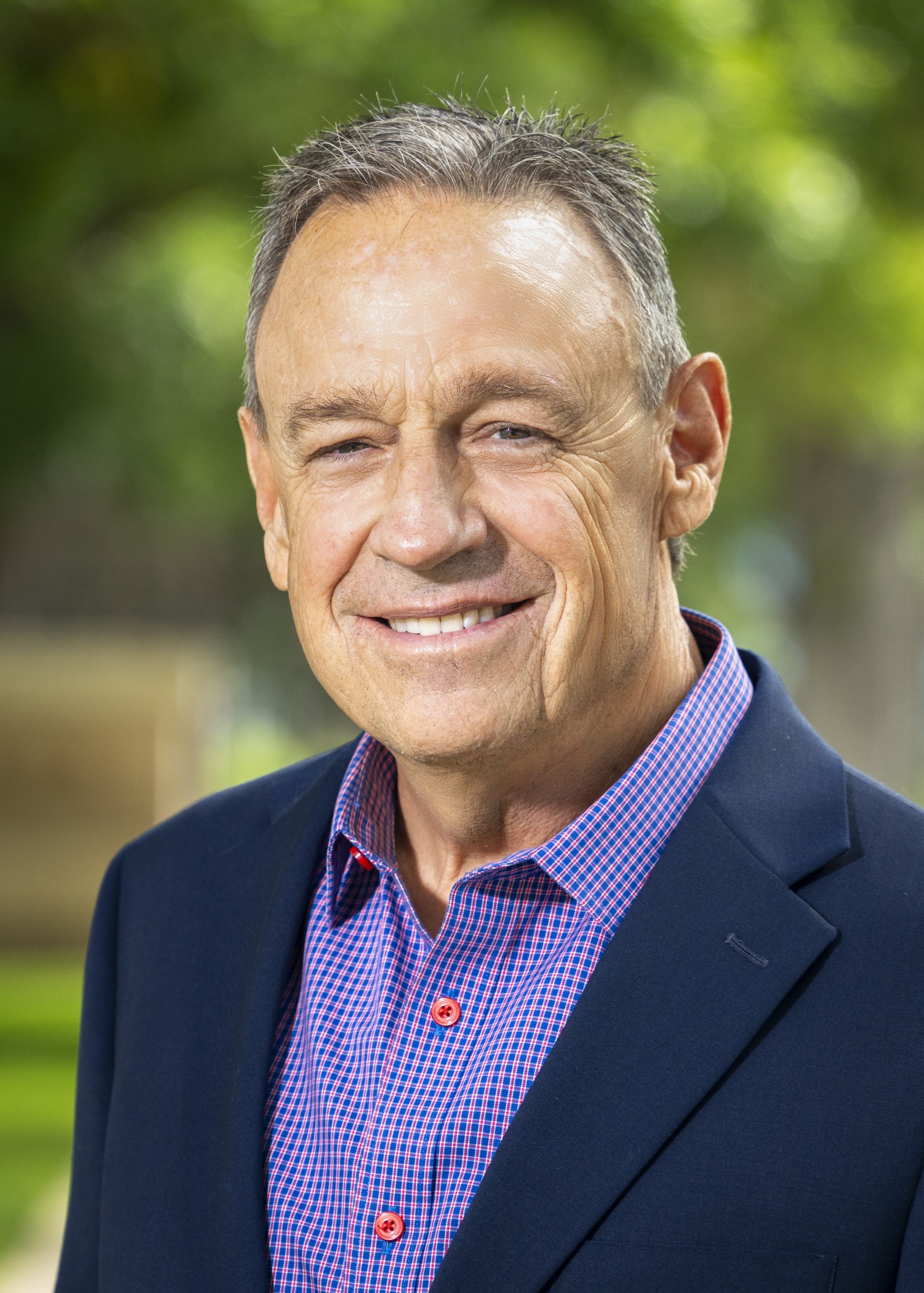 a man in a suit smiling
