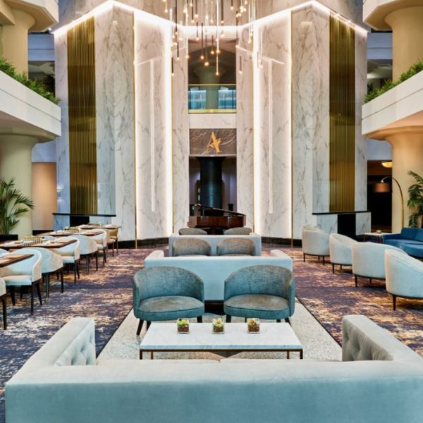 a room with a large chandelier and tables