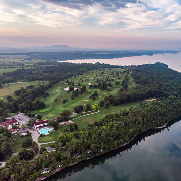 an aerial view of a golf course and a body of water