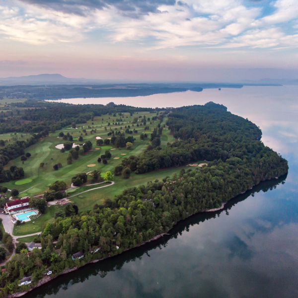 an island with trees and a pool in the middle of it