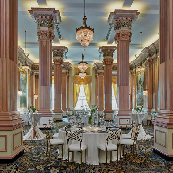 a room with a chandelier and tables
