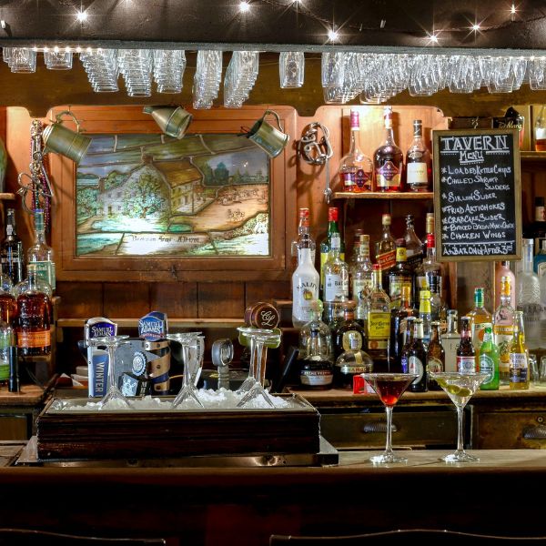 a bar with many bottles of alcohol