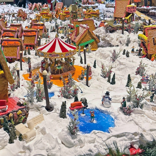 a gingerbread village with snow and trees
