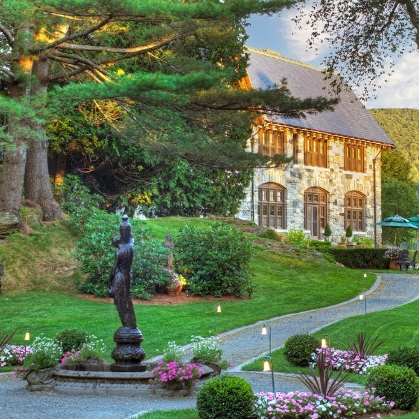 a stone building with a statue in front of it