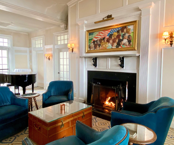 a room with blue chairs and a piano