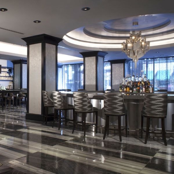 a bar with chairs and a chandelier