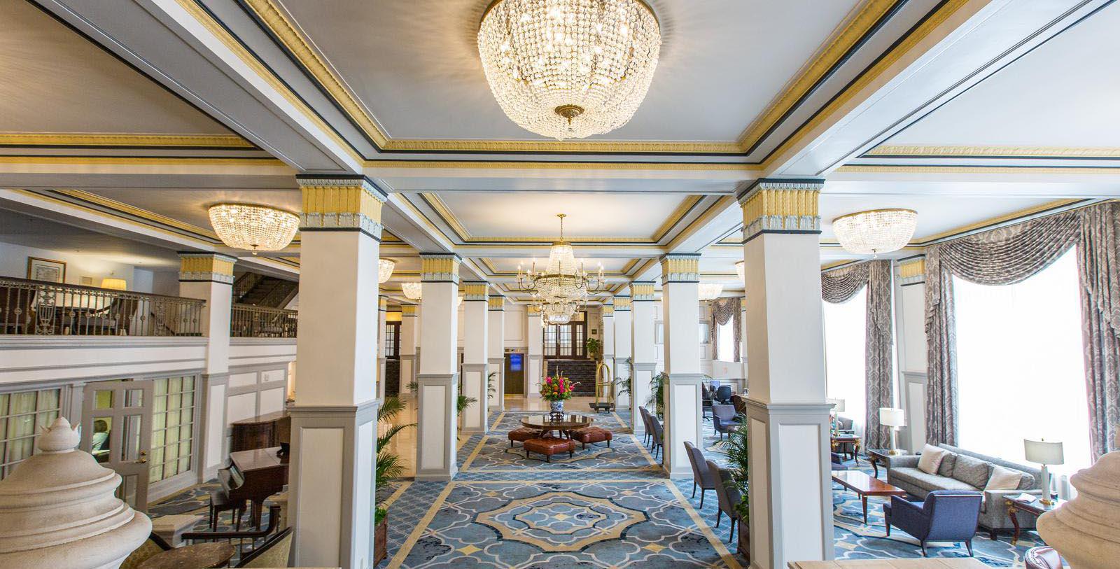 a large room with columns and chandeliers 0