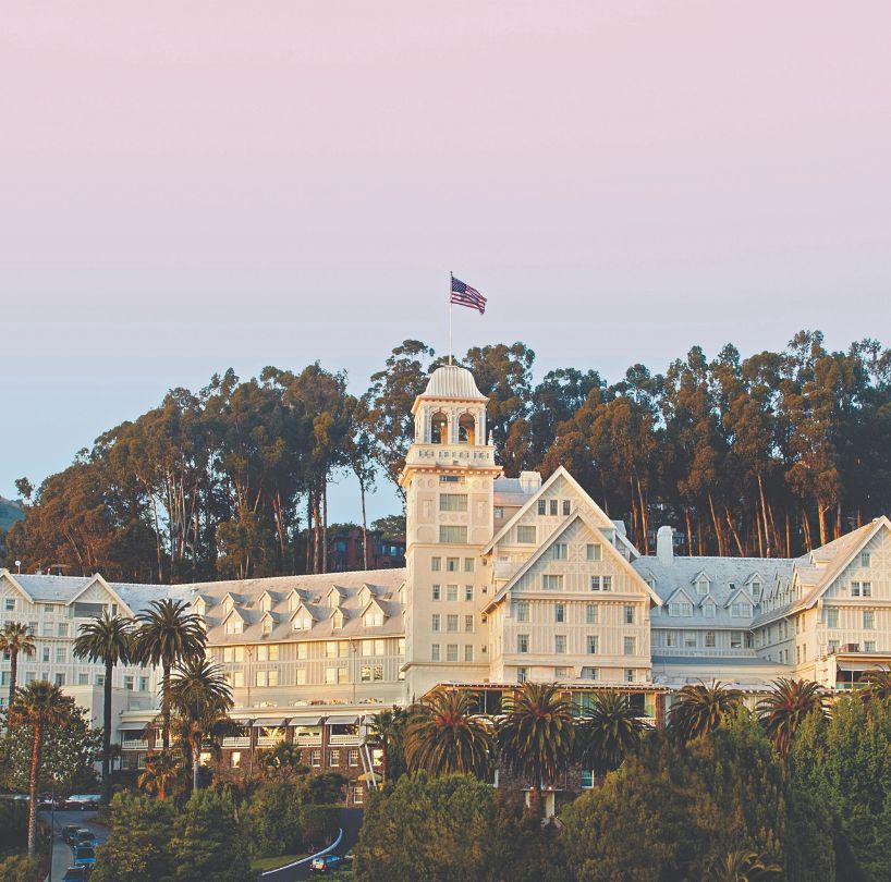 a large white building with a flag on top