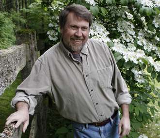 a man leaning on a fence