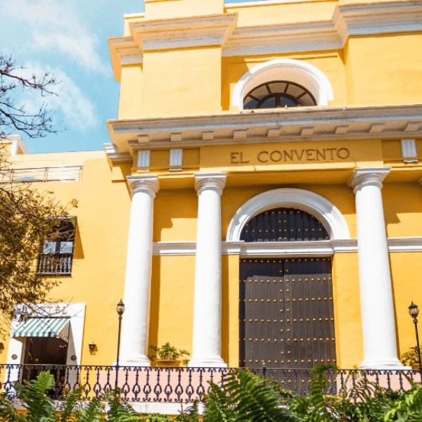 a yellow building with white pillars