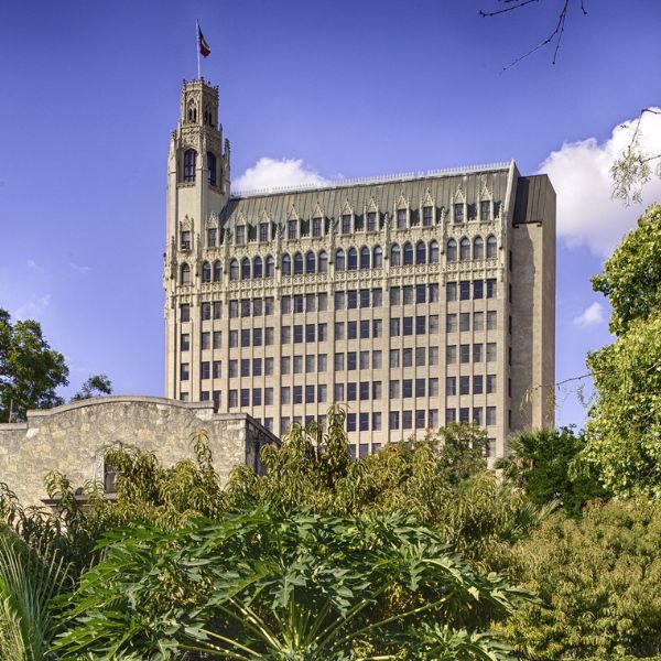 a building with a tower and a stone wall