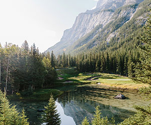 a lake surrounded by trees and mountains
