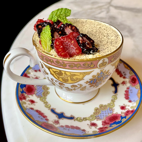 a cup of coffee with fruit on top