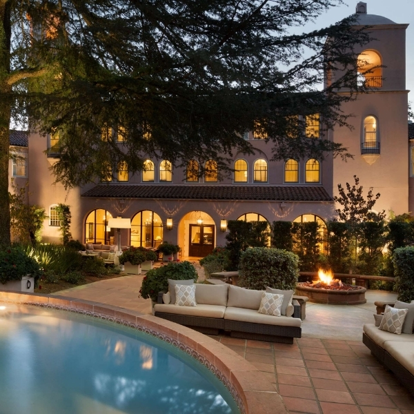 a pool with a large building and a couch