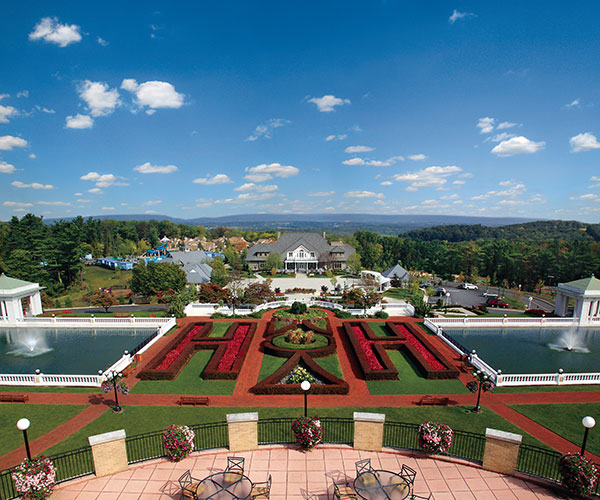 a pool and a building with a large garden