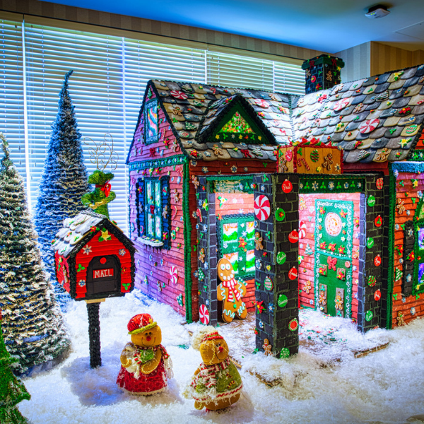 a gingerbread house with trees and snow