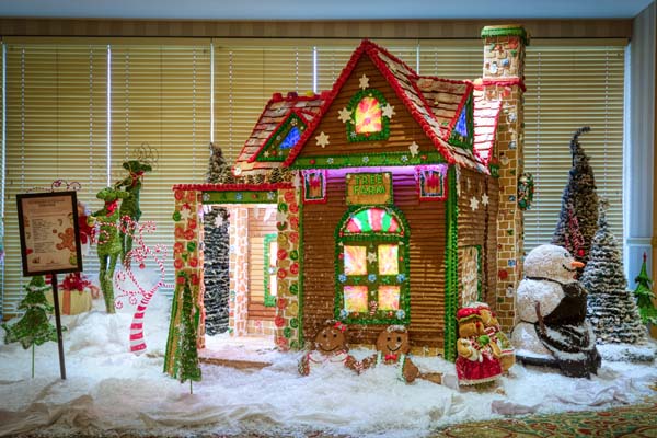 a gingerbread house with snowman and snowman