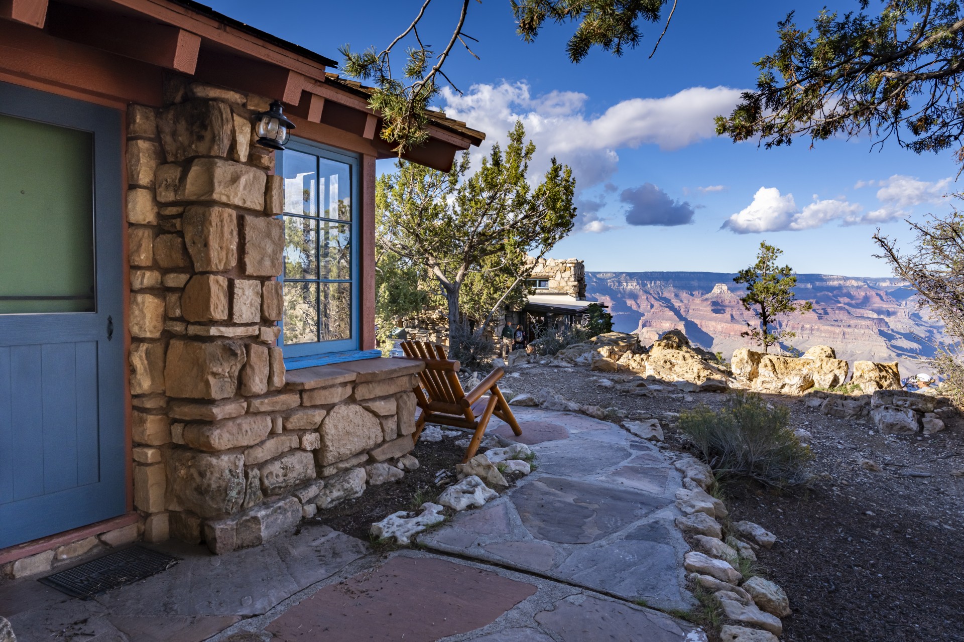 a stone building with a chair on the side