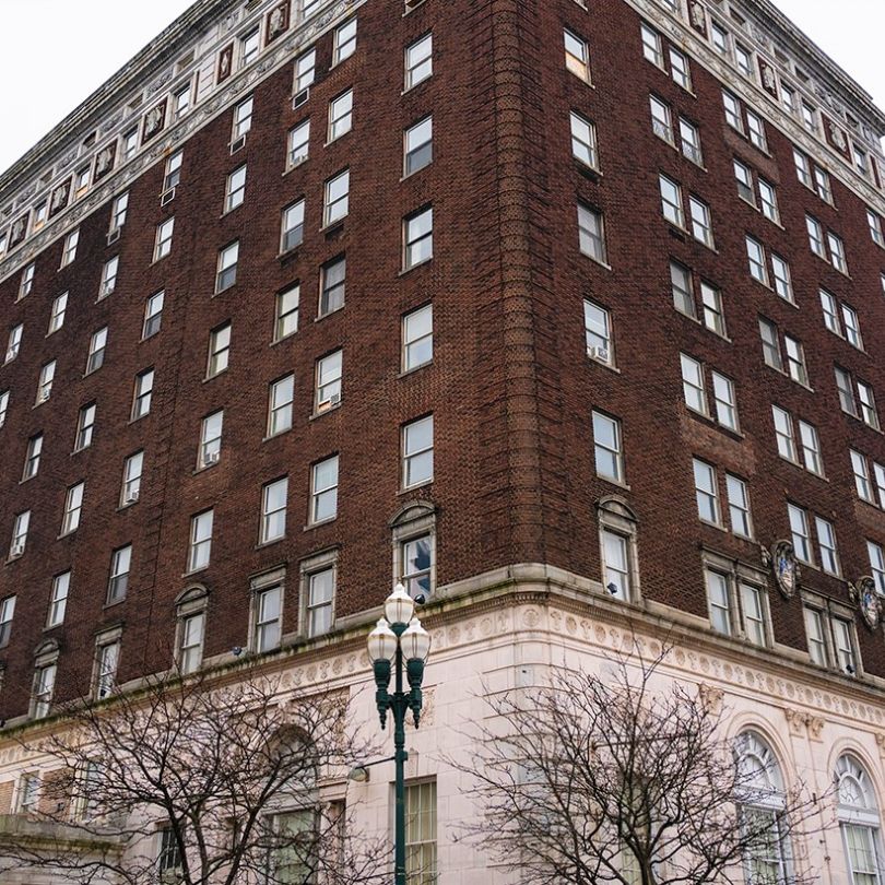 a tall brick building with a street light