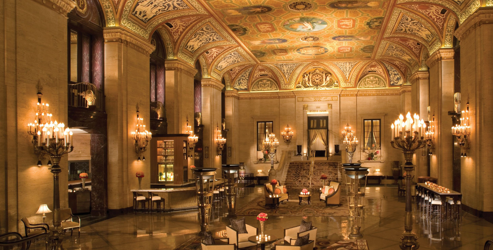 a large ornate room with chandeliers and tables