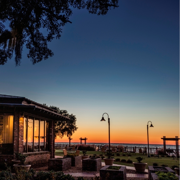 a building with a view of the ocean and a sunset