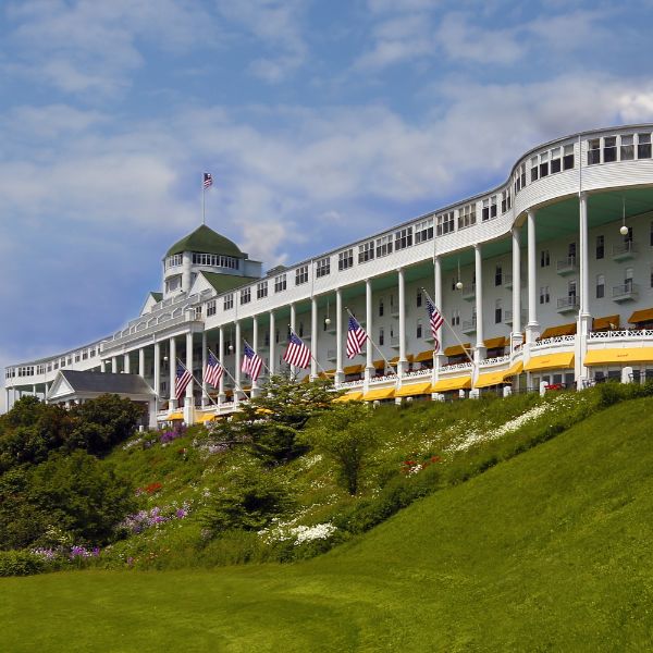 a large white building with many flags on the front