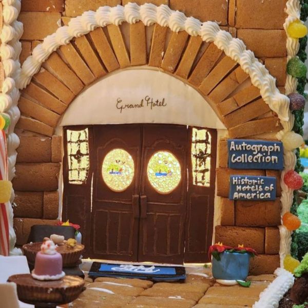 a gingerbread house with a door and a sign