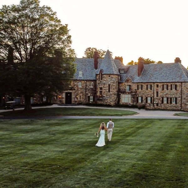 a man and woman walking in a lawn