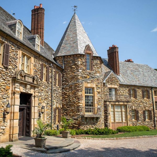 a large stone building with a round driveway