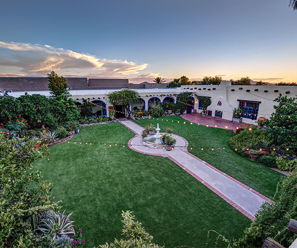 a courtyard with a fountain and trees