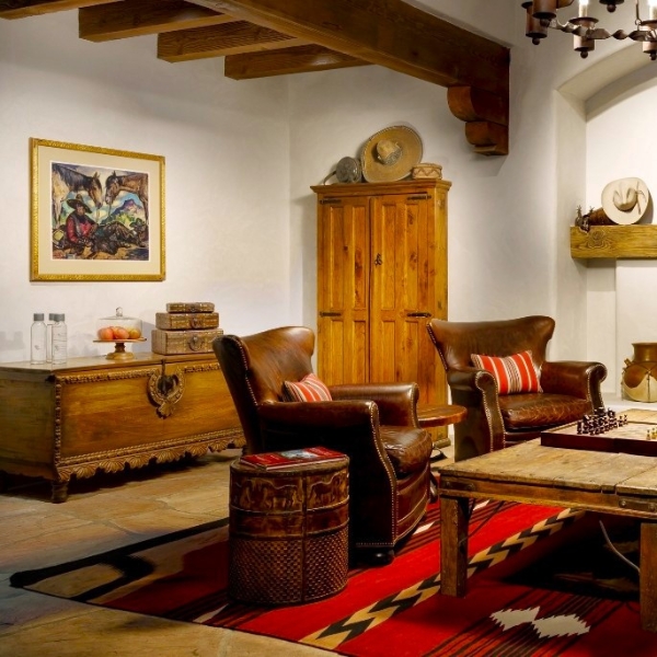 a living room with a rug and chairs