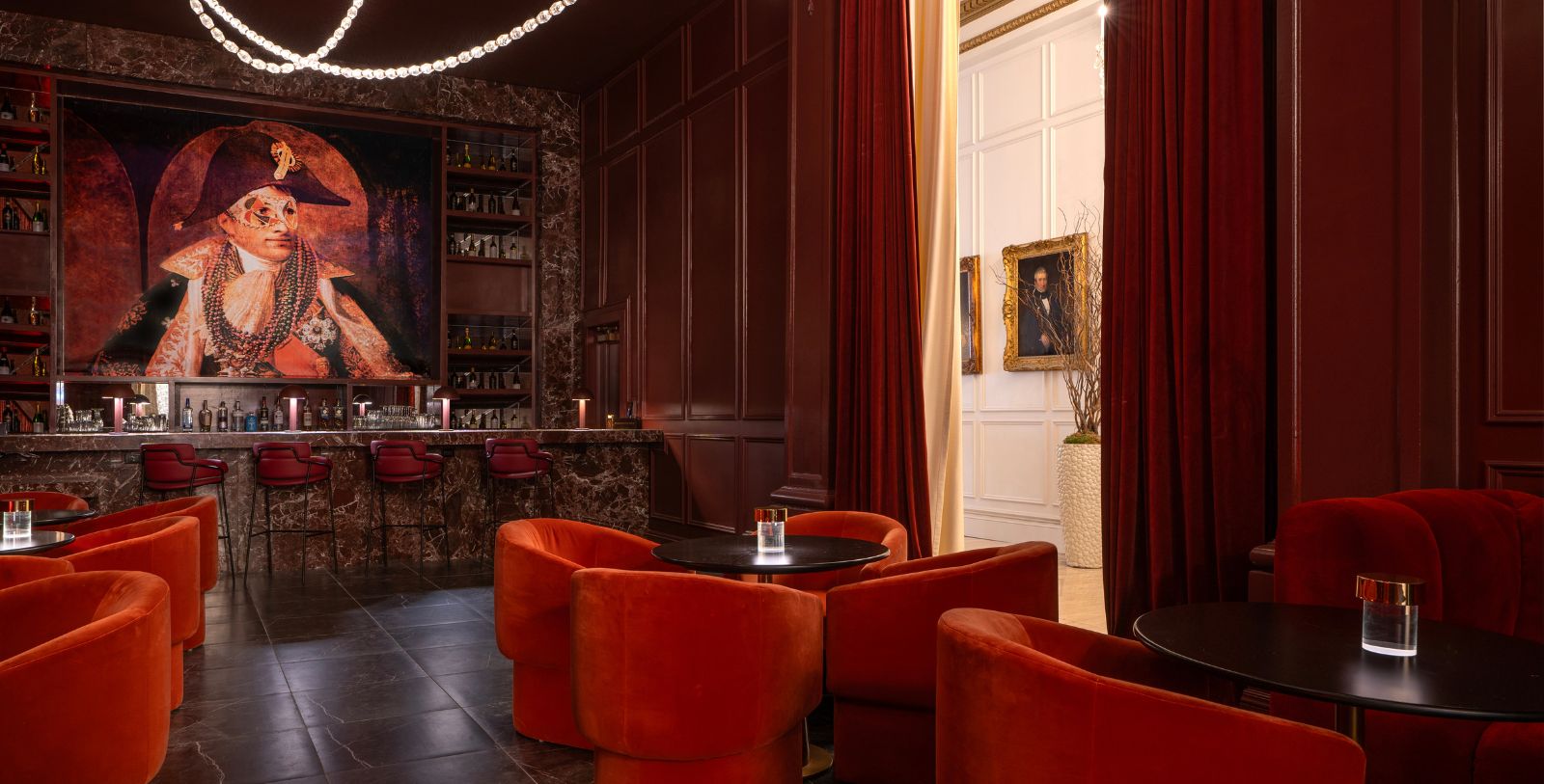 a room with red chairs and a bar
