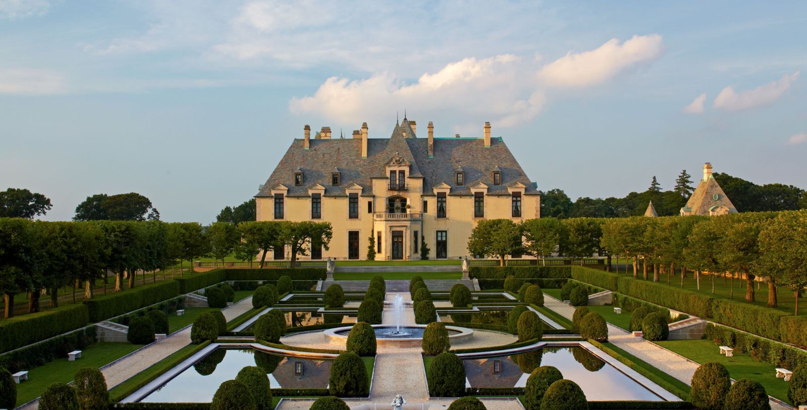 a large mansion with a fountain in front of it