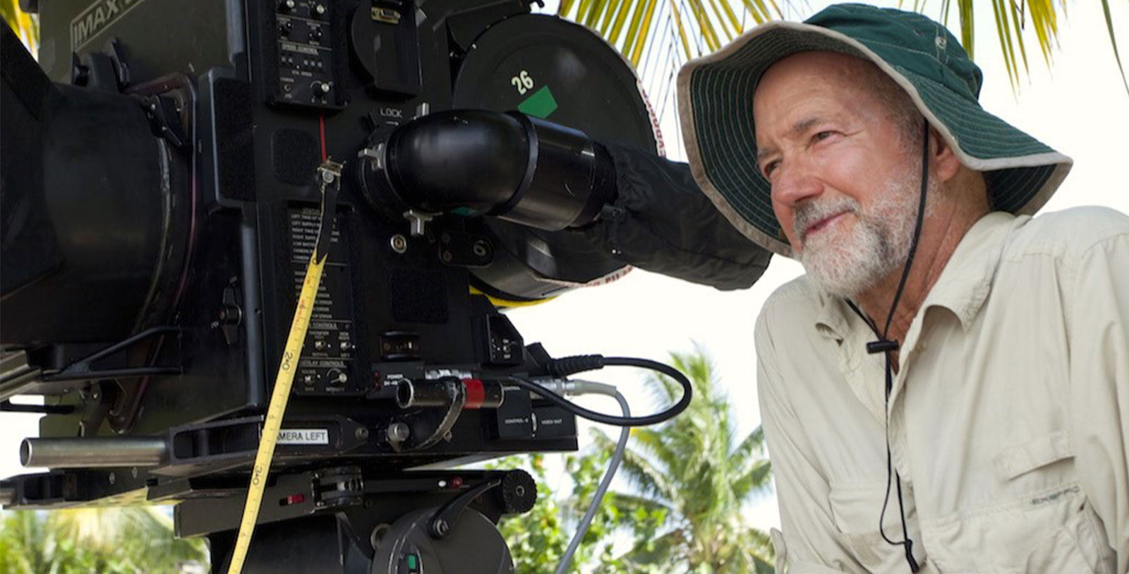 a man in a hat looking at a camera