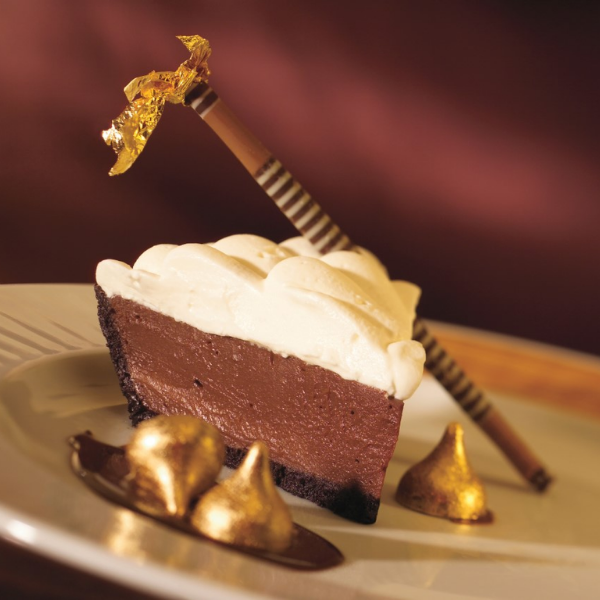 a piece of chocolate pie with a straw on top