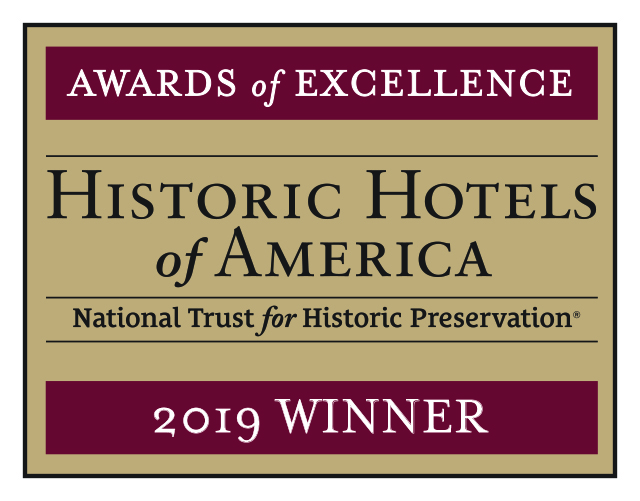 a brown and white rectangular sign with black text