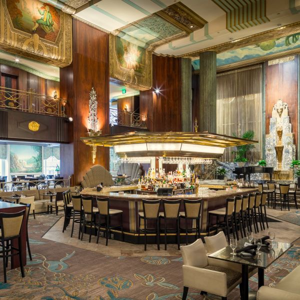 a large room with a bar and chairs