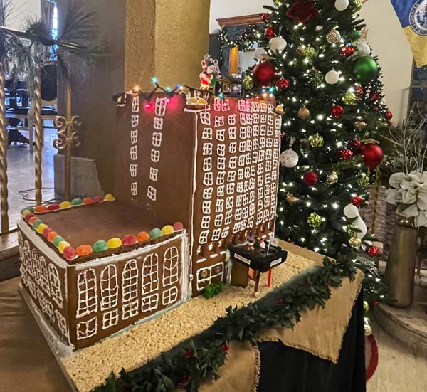 a gingerbread house with a christmas tree