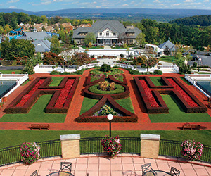 a large garden with a large building in the background
