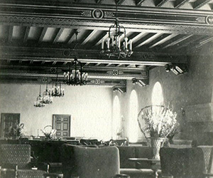 a room with a chandelier and chairs