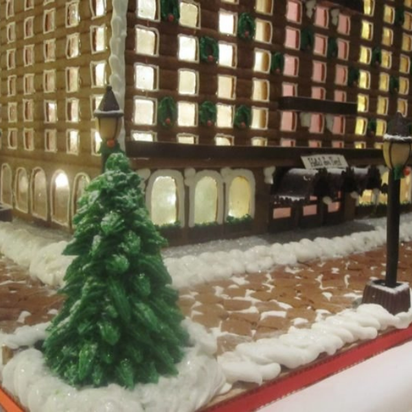a gingerbread house with a tree and street lights