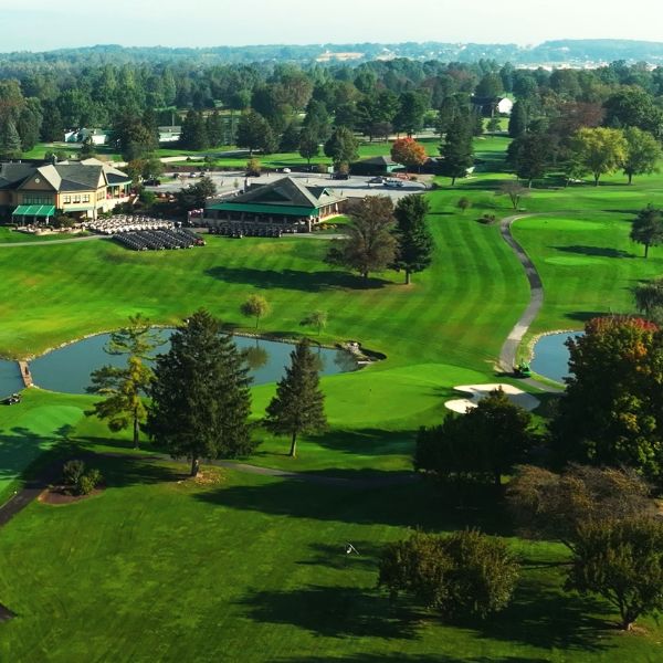 a golf course with a building and trees