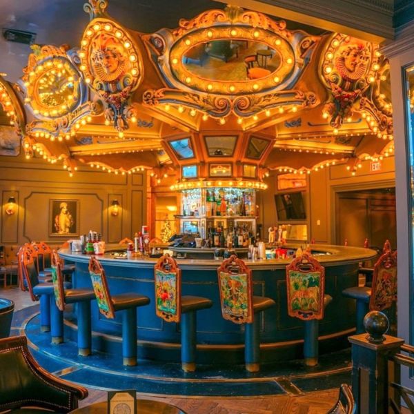 a bar with lights and chairs