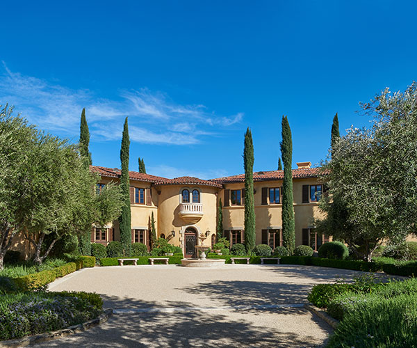 a large house with a courtyard and trees