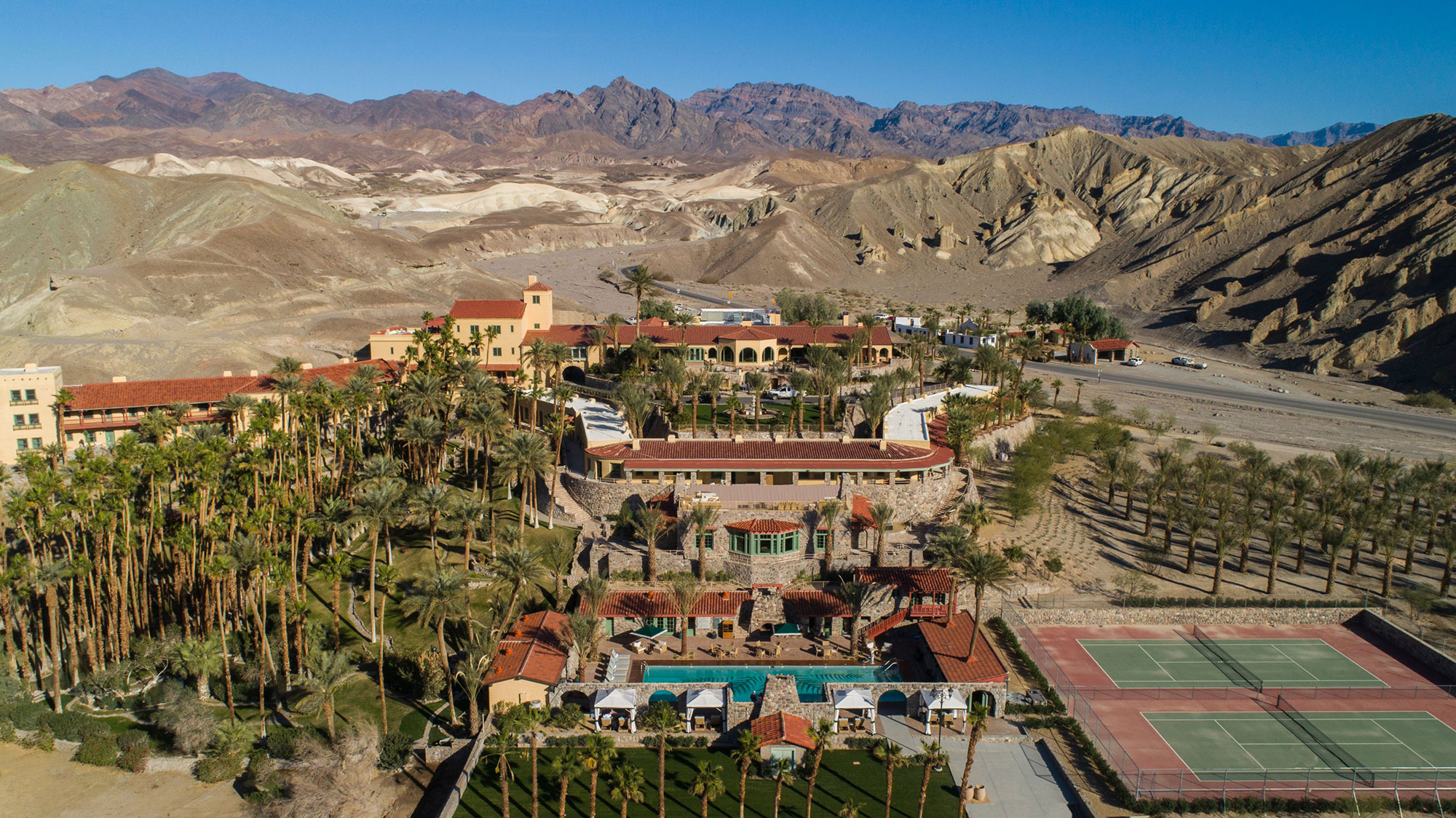 a resort with a swimming pool and palm trees 3