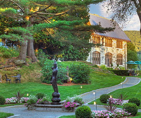 a stone building with a fountain and a fountain in front of it