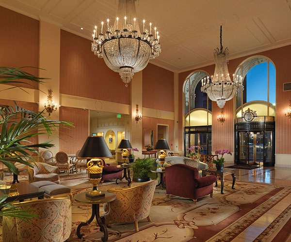 a large lobby with chandeliers and chairs