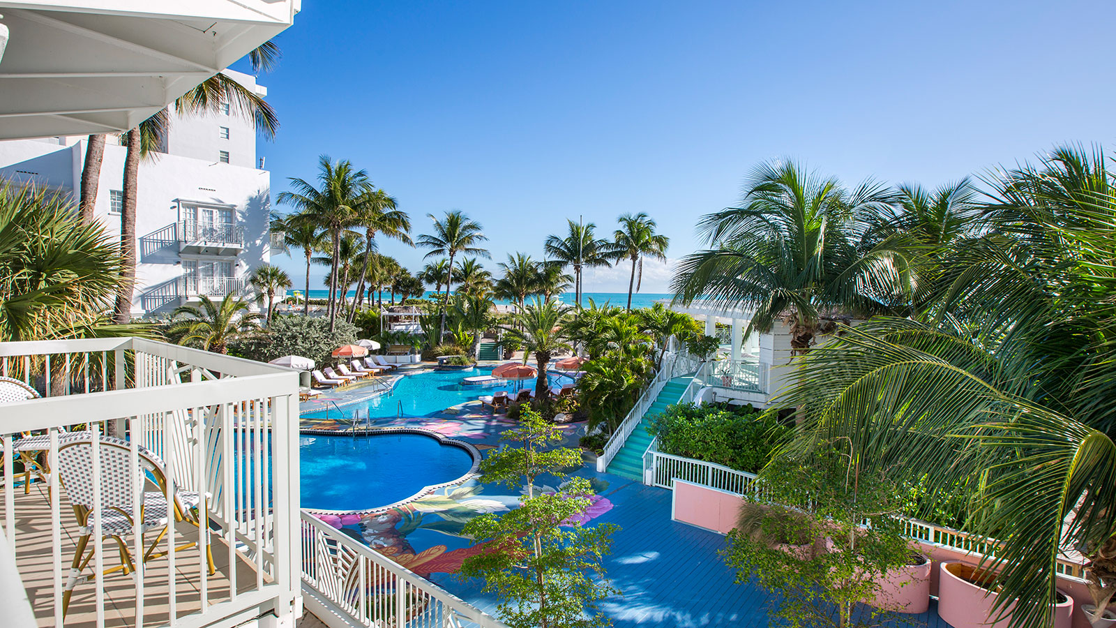 a pool with palm trees and a deck