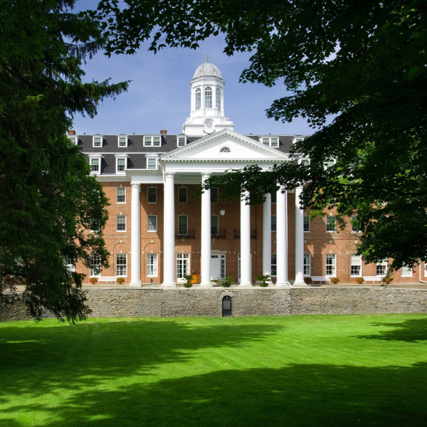 a building with columns and a lawn
